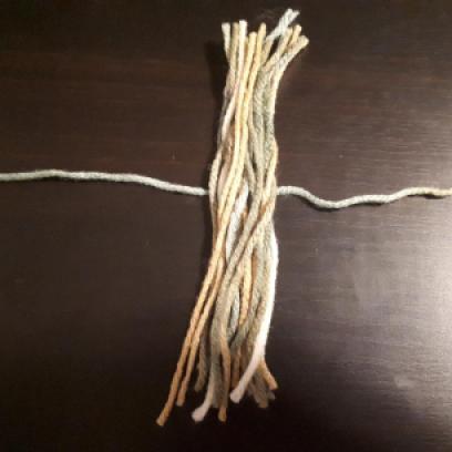 Tassle lie yarn over strap